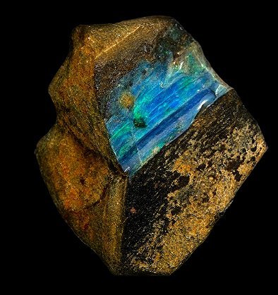 Boulder opal — brown ironstone split by a bright blue-green opal seam